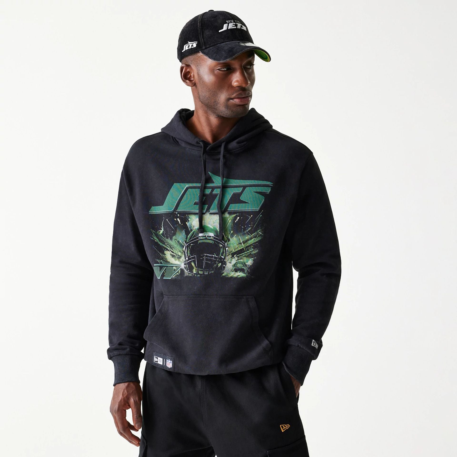 The Male model is wearing New York Jets NFL Games Premium Apparel Black Oversized Pullover Hoodie 1