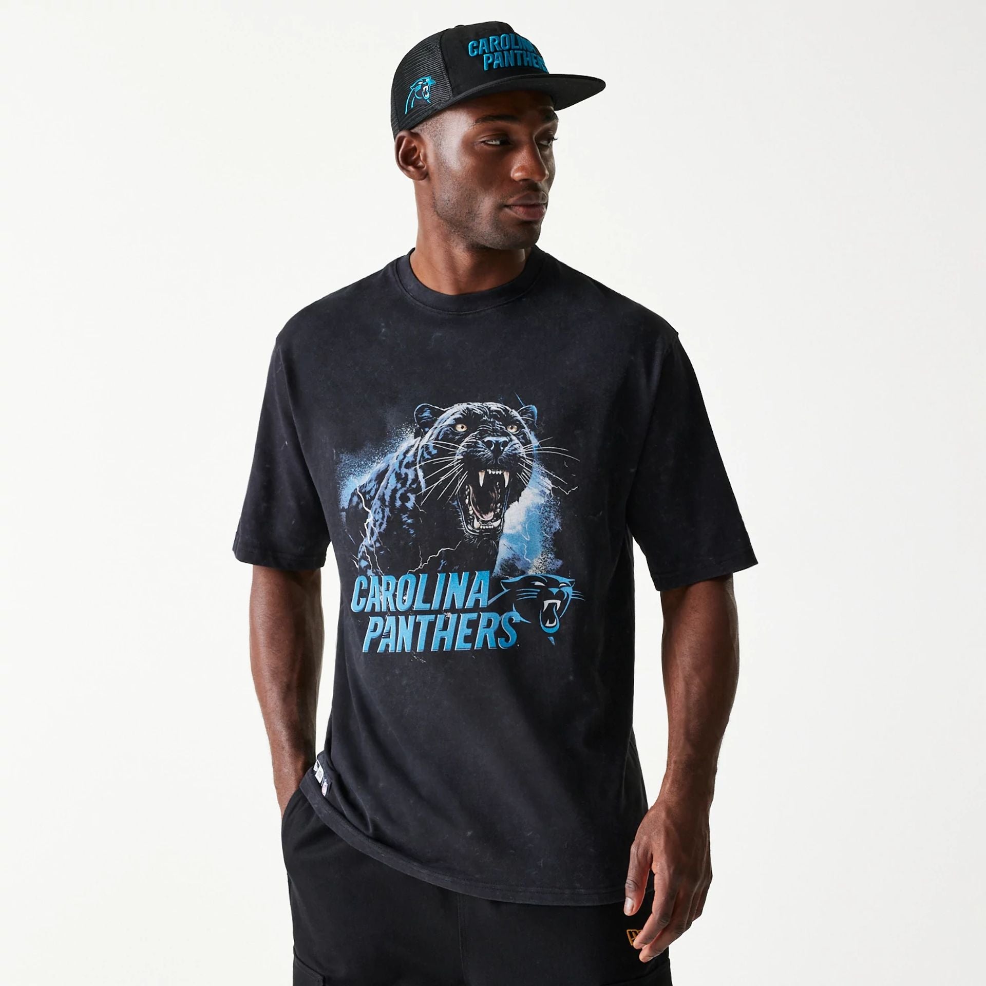 The Male model is wearing Carolina Panthers NFL Games Premium Apparel Black Oversized T-Shirt 1