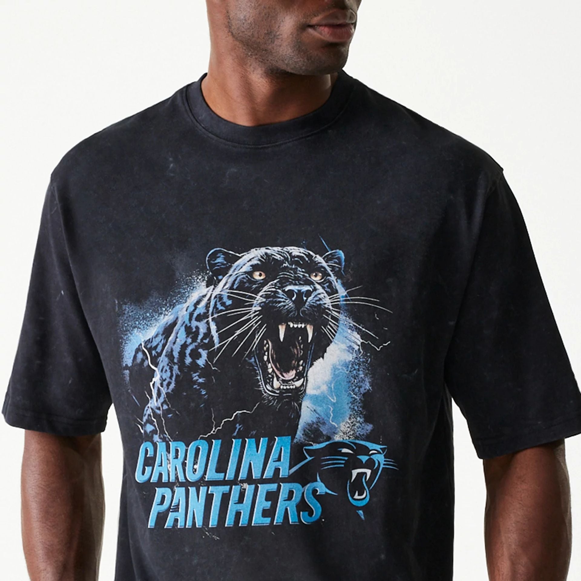 The Male model is wearing Carolina Panthers NFL Games Premium Apparel Black Oversized T-Shirt 2