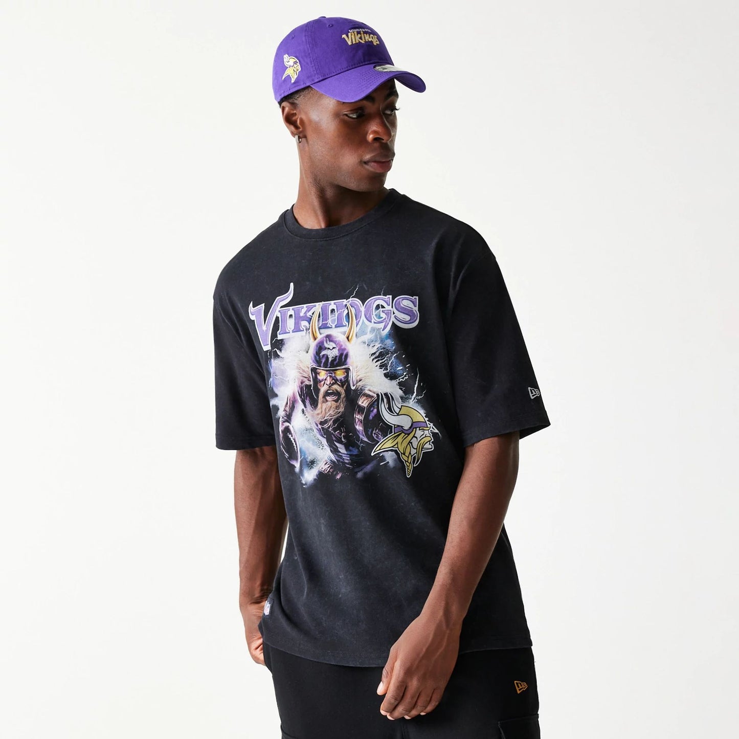 The Male model is wearing Minnesota Vikings NFL Games Premium Apparel Black Oversized T-Shirt 1