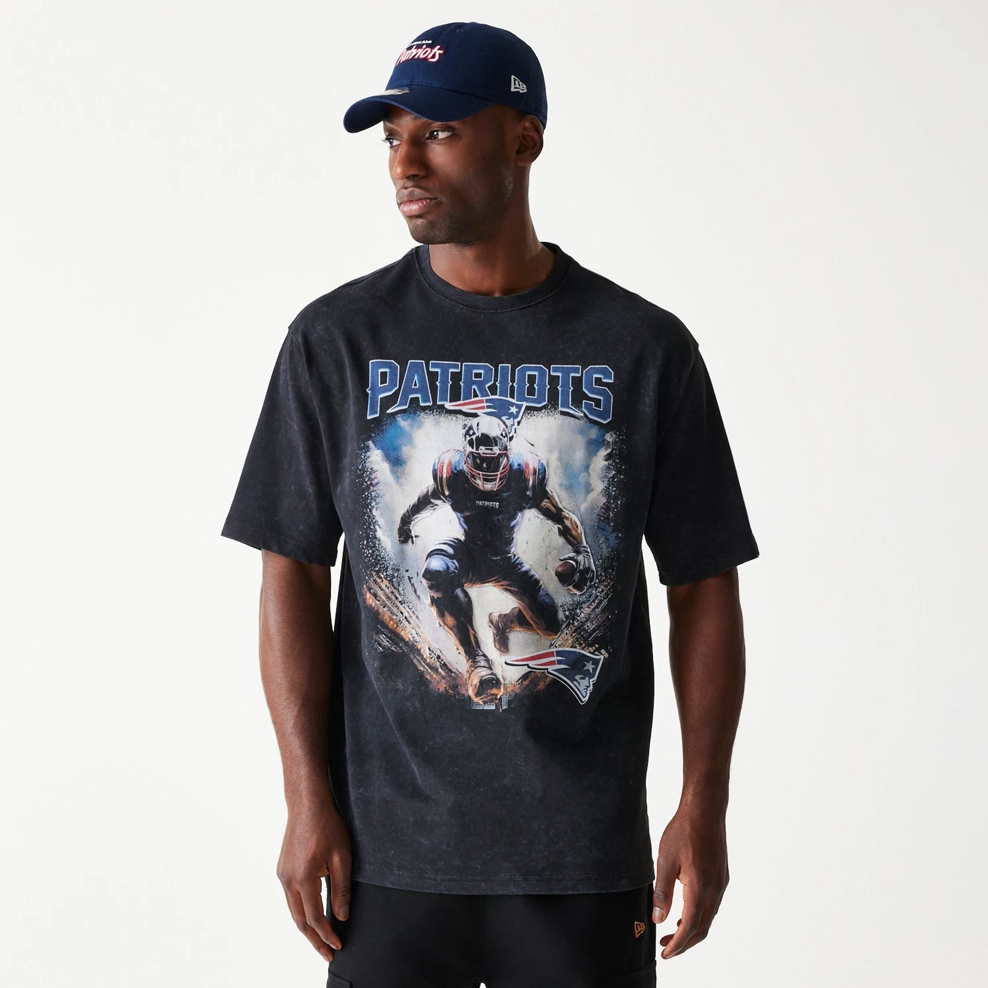 The Male model is wearing New England Patriots NFL Games Premium Apparel Black Oversized T-Shirt 1