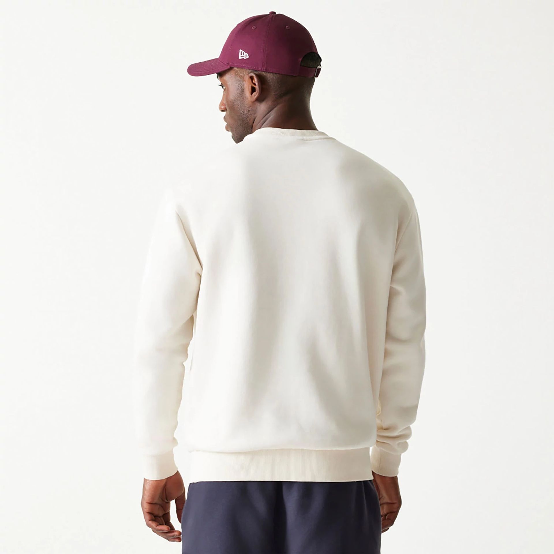 The Male model is wearing New Era Essential Brushed Fleece White Crewneck Sweater 2