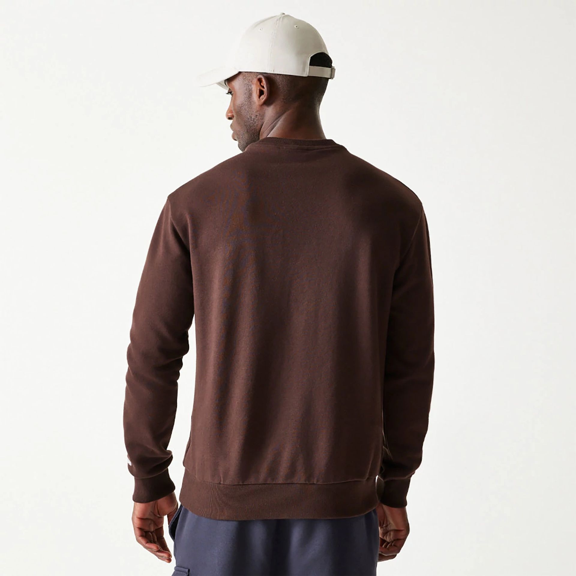 The Male model is wearing New Era Essential Dark Brown Crewneck Sweater 2