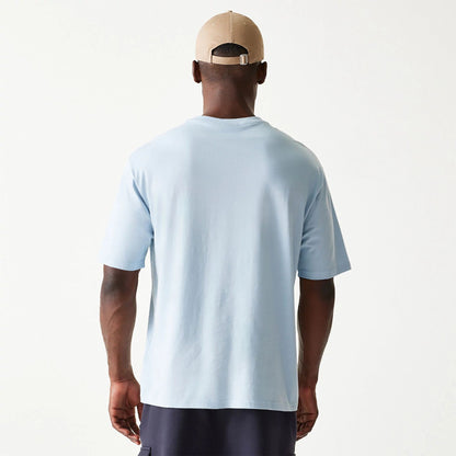 The Male model is wearing New Era Essential Pastel Blue Oversized T-Shirt 2