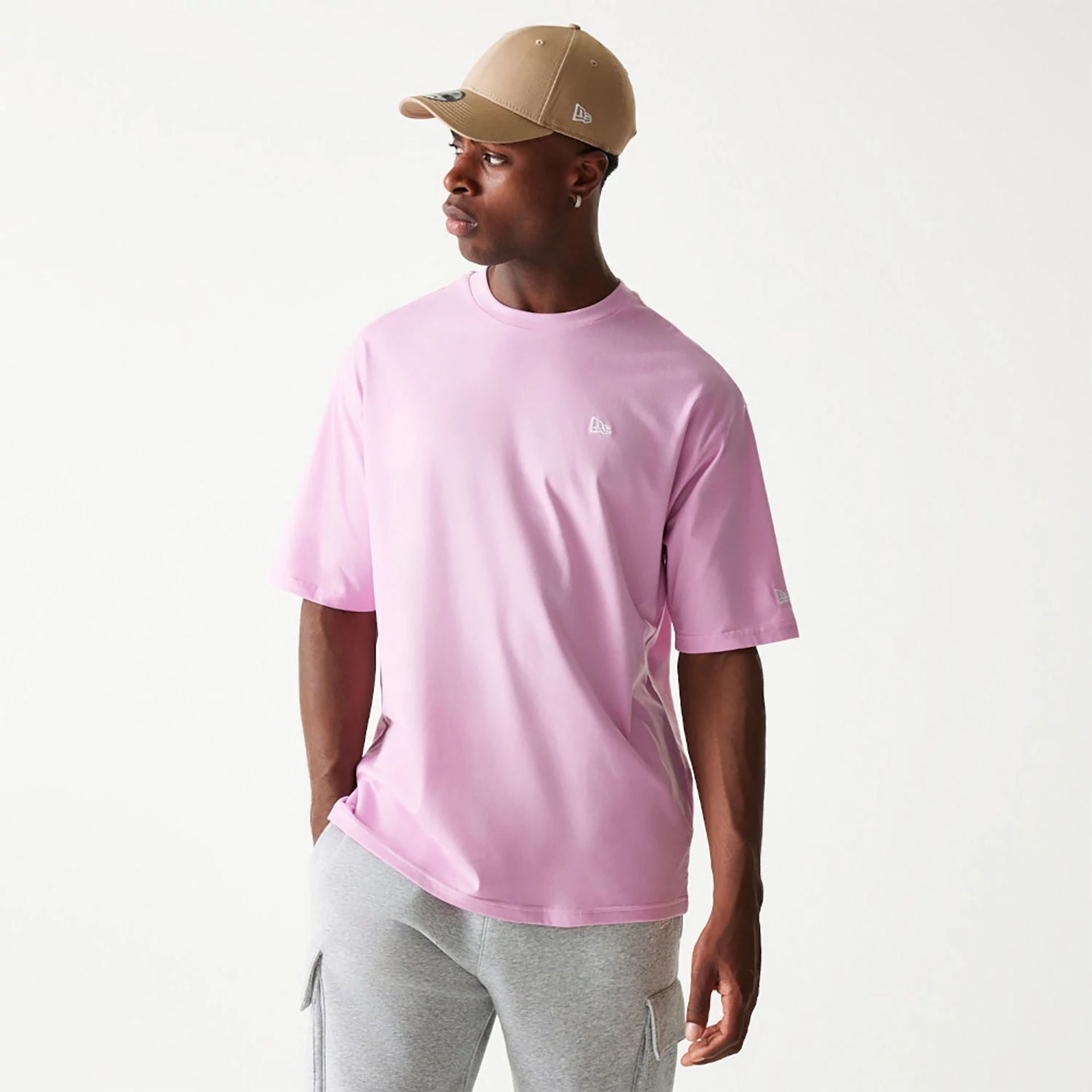 The Male model is wearing New Era Essential Pastel Pink Oversized T-Shirt 1