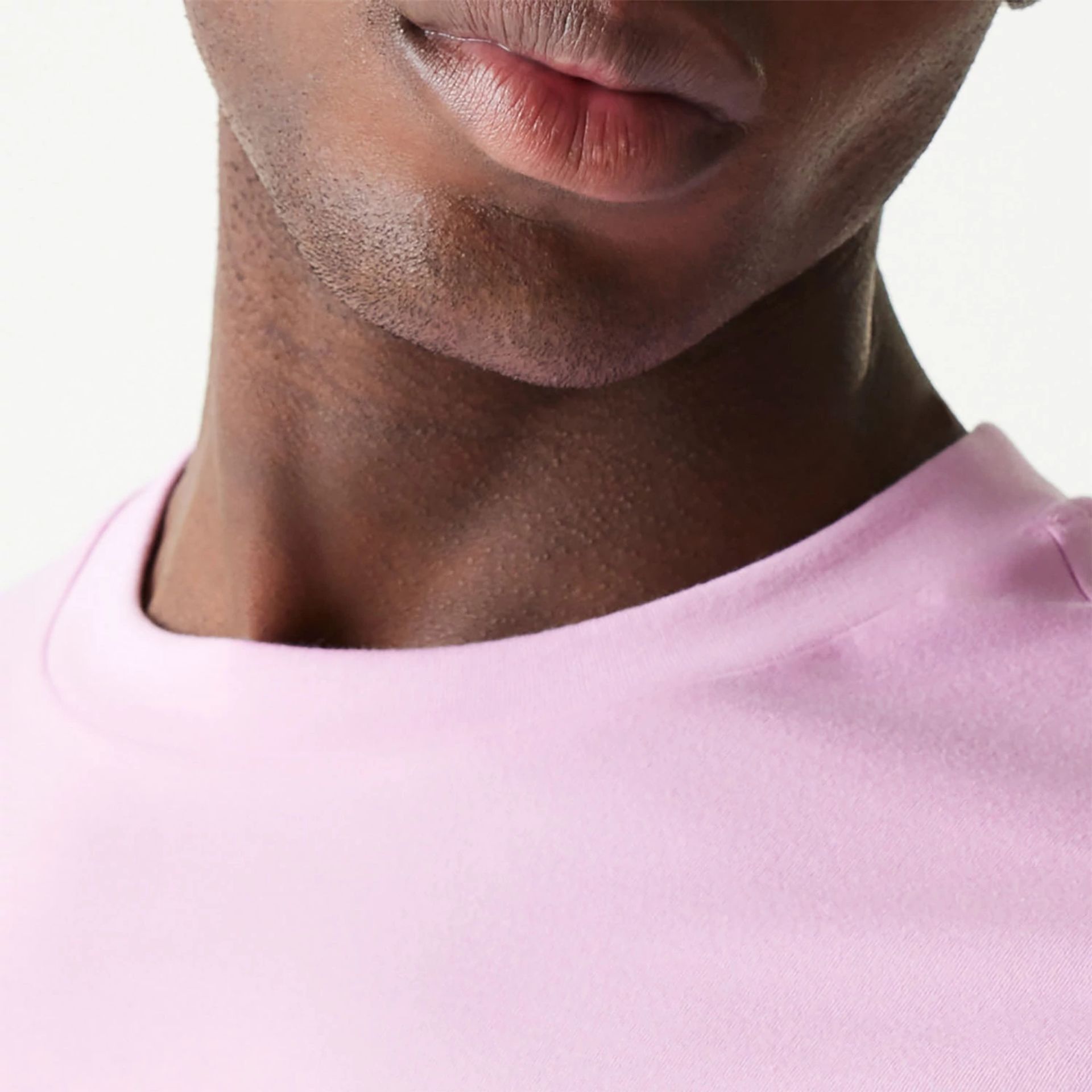 The Male model is wearing New Era Essential Pastel Pink Oversized T-Shirt 6