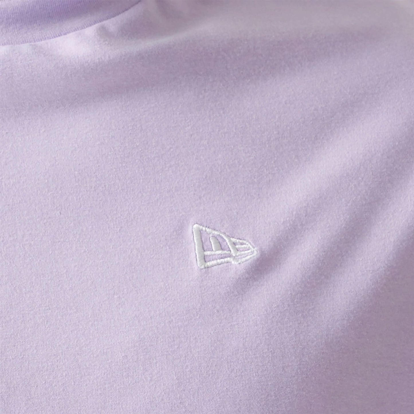 The Male model is wearing New Era Essential Pastel Purple Oversized T-Shirt 7