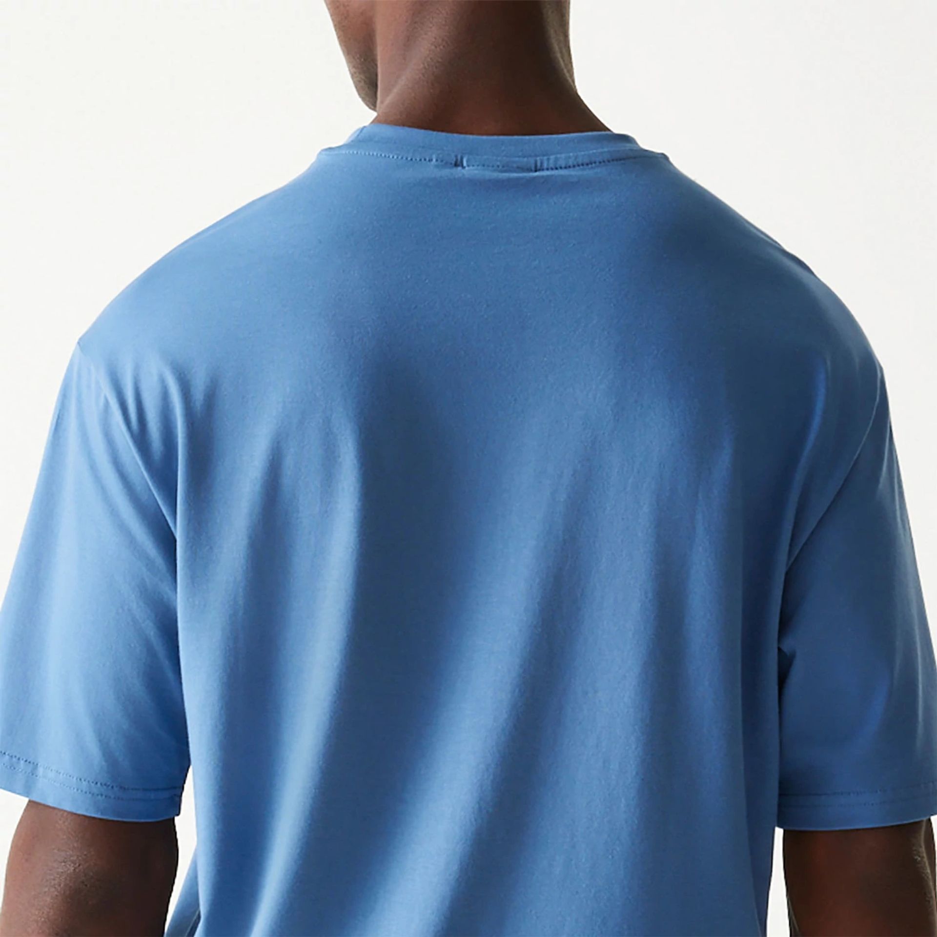 The Male model is wearing New Era Essential Blue Oversized T-Shirt 7