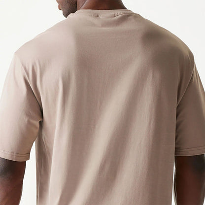 The Male model is wearing New Era Essential Pastel Brown Oversized T-Shirt 7