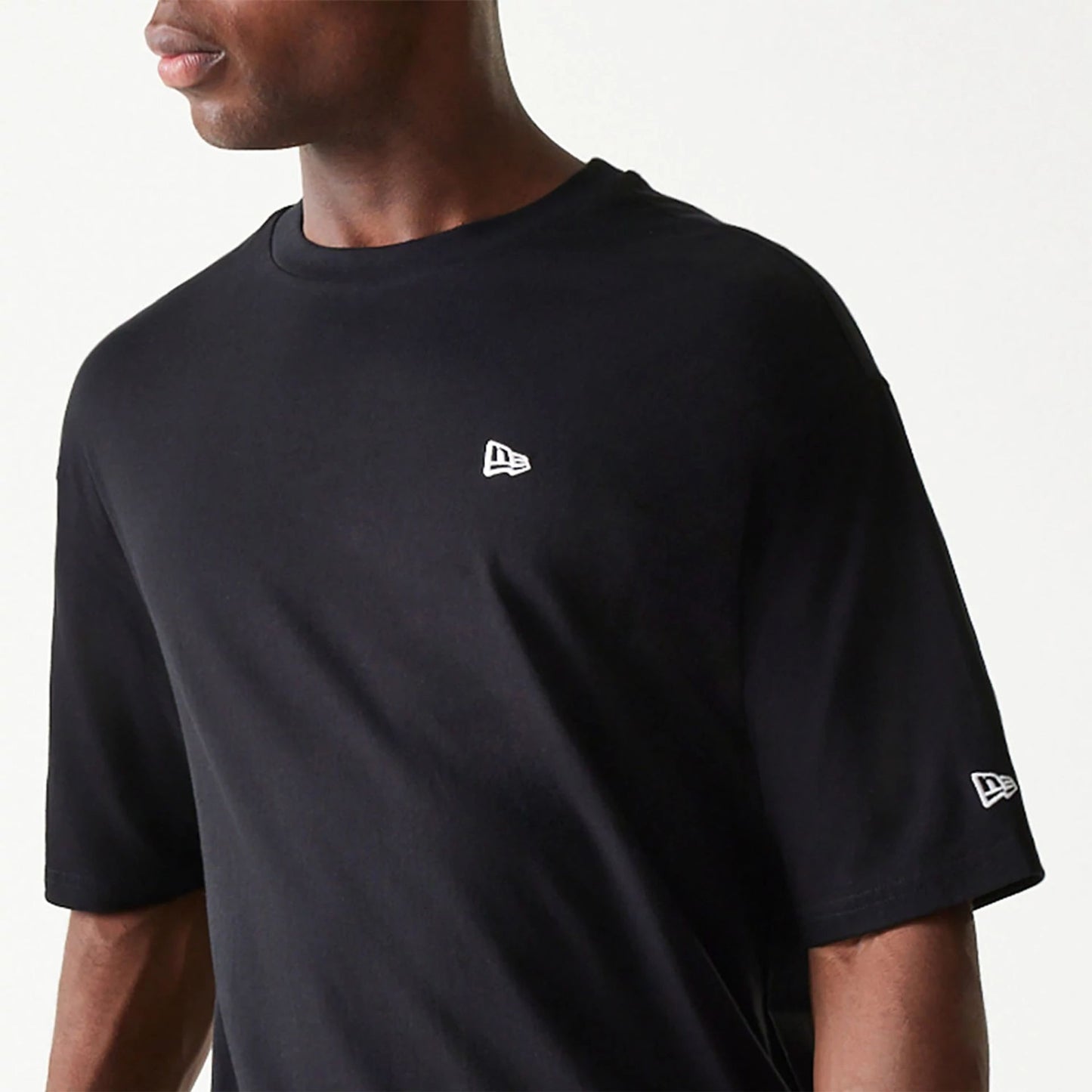 The Male model is wearing New Era Essential Black Oversized T-Shirt 3