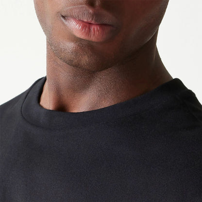 The Male model is wearing New Era Essential Black Oversized T-Shirt 6