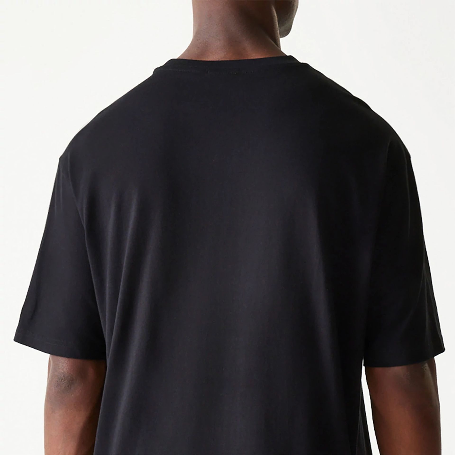 The Male model is wearing New Era Essential Black Oversized T-Shirt 7