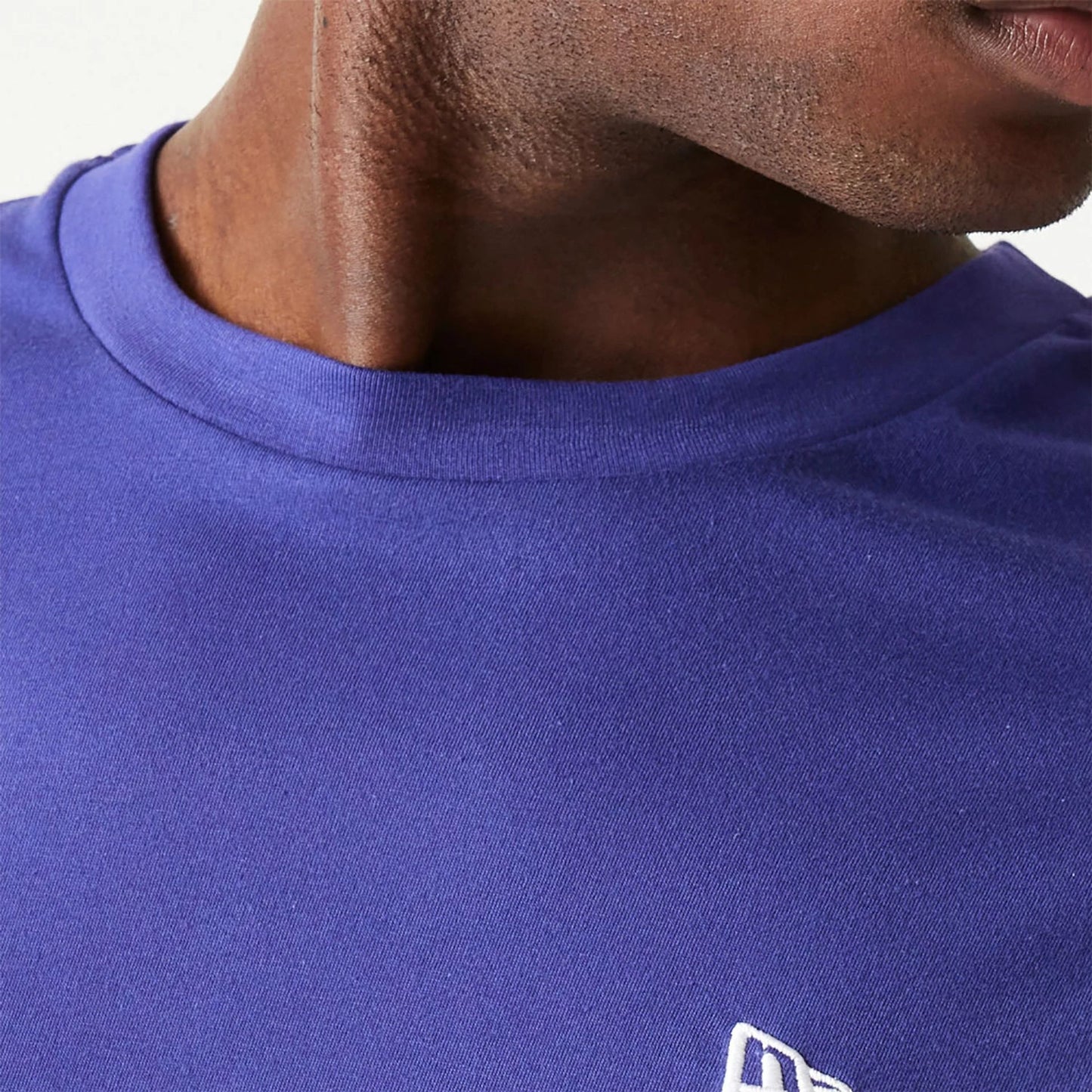 The Male model is wearing New Era Essential Dark Purple Oversized T-Shirt 6