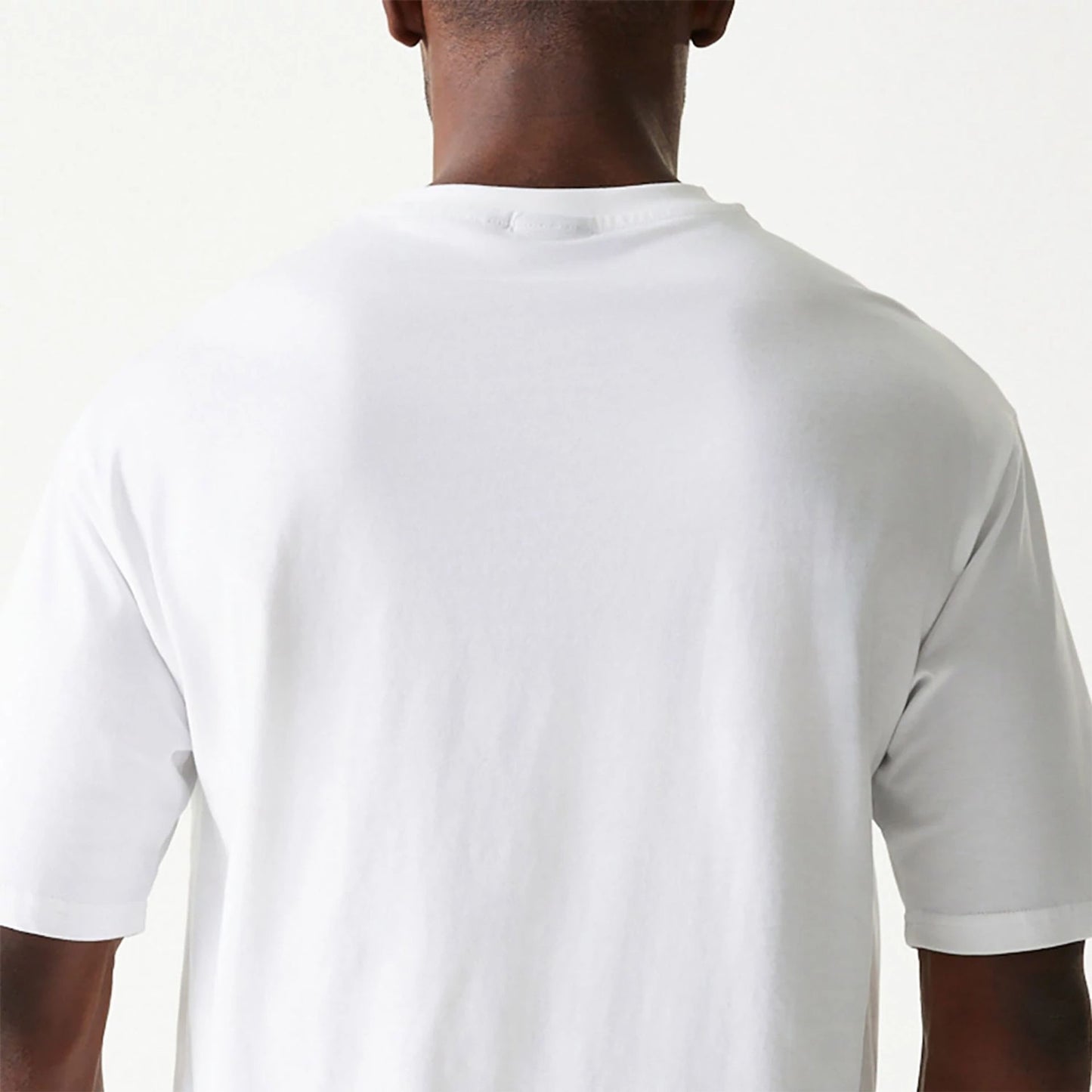 The Male model is wearing New Era Essential White Oversized T-Shirt 7