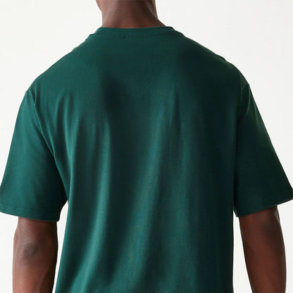 The Male model is wearing New Era Essential Dark Green Oversized T-Shirt 7