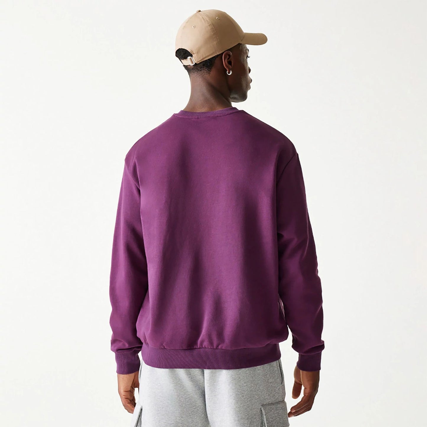 The Male model is wearing New Era Essential Brushed Fleece Dark Purple Crewneck Sweater 2