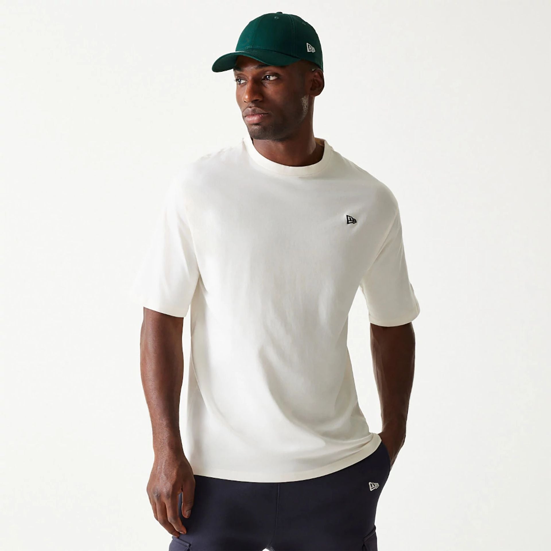 The Male model is wearing New Era Essential Cream Oversized T-Shirt 1