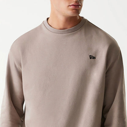 The Male model is wearing New Era Essential Brushed Fleece Pastel Brown Crewneck Sweater 3