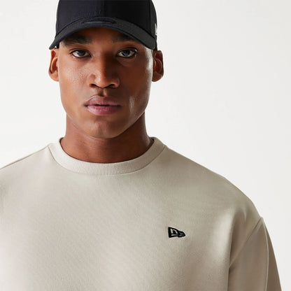 The Male model is wearing New Era Essential Brushed Fleece Light Beige Crewneck Sweater 4