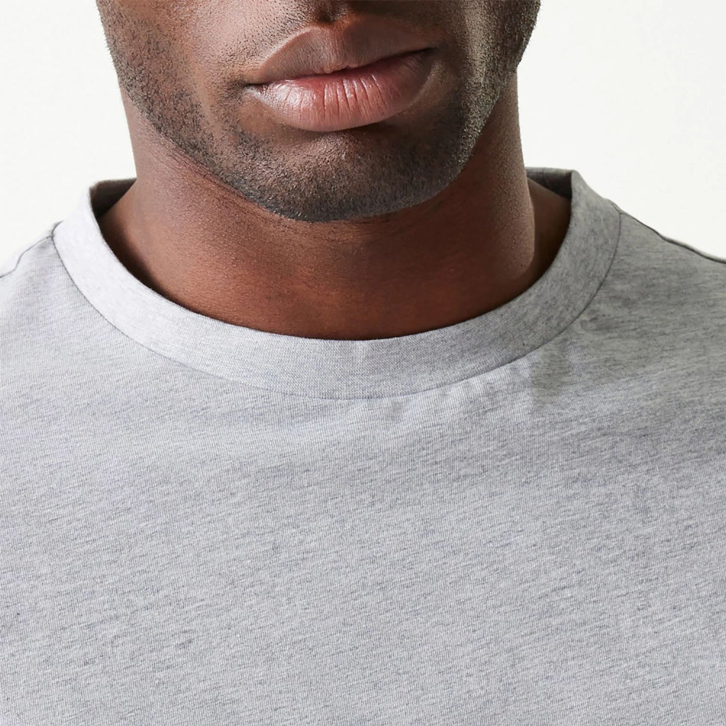 The Male model is wearing New Era Essential Grey Oversized T-Shirt 6