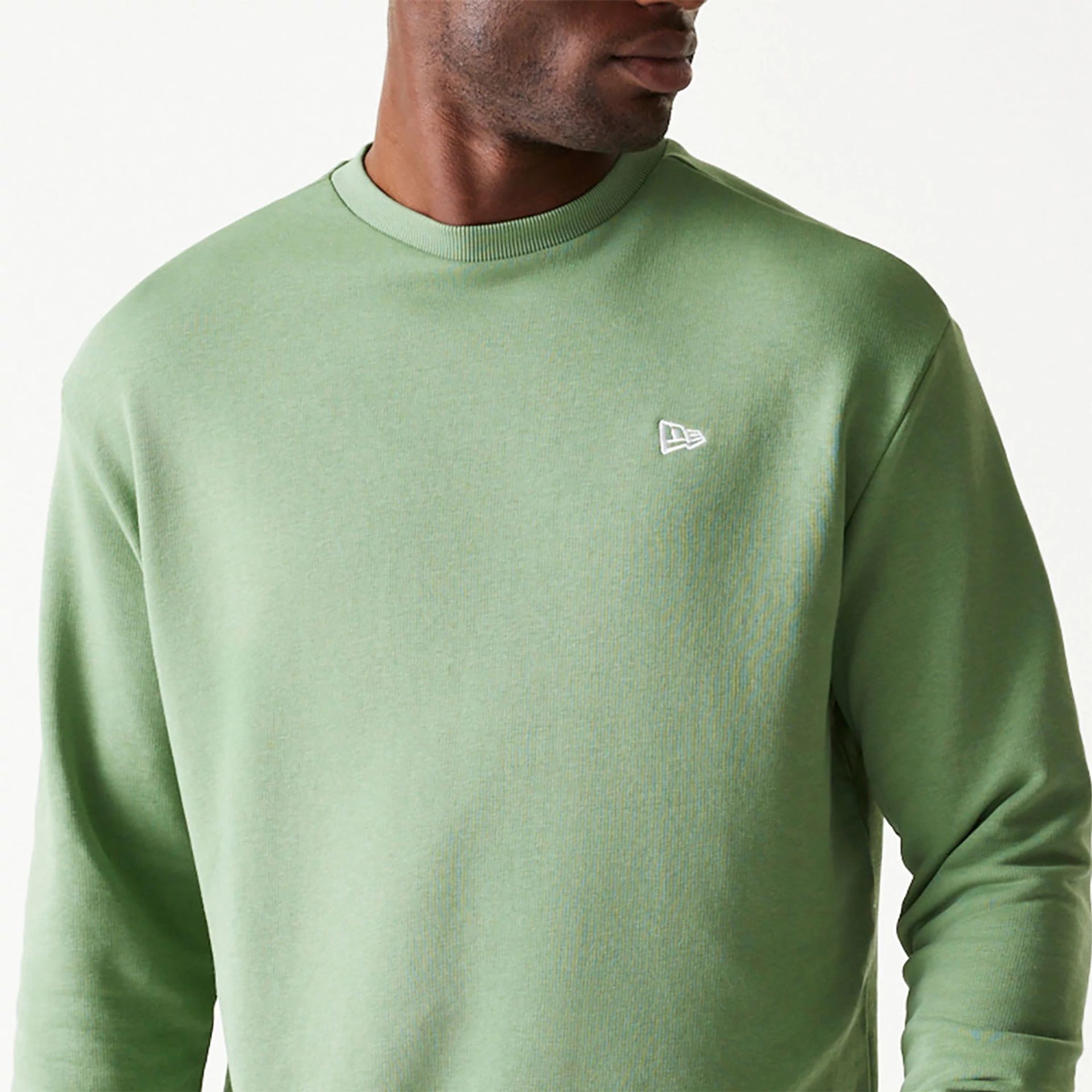 The Male model is wearing New Era Essential Pastel Green Oversized Crewneck Sweater 3