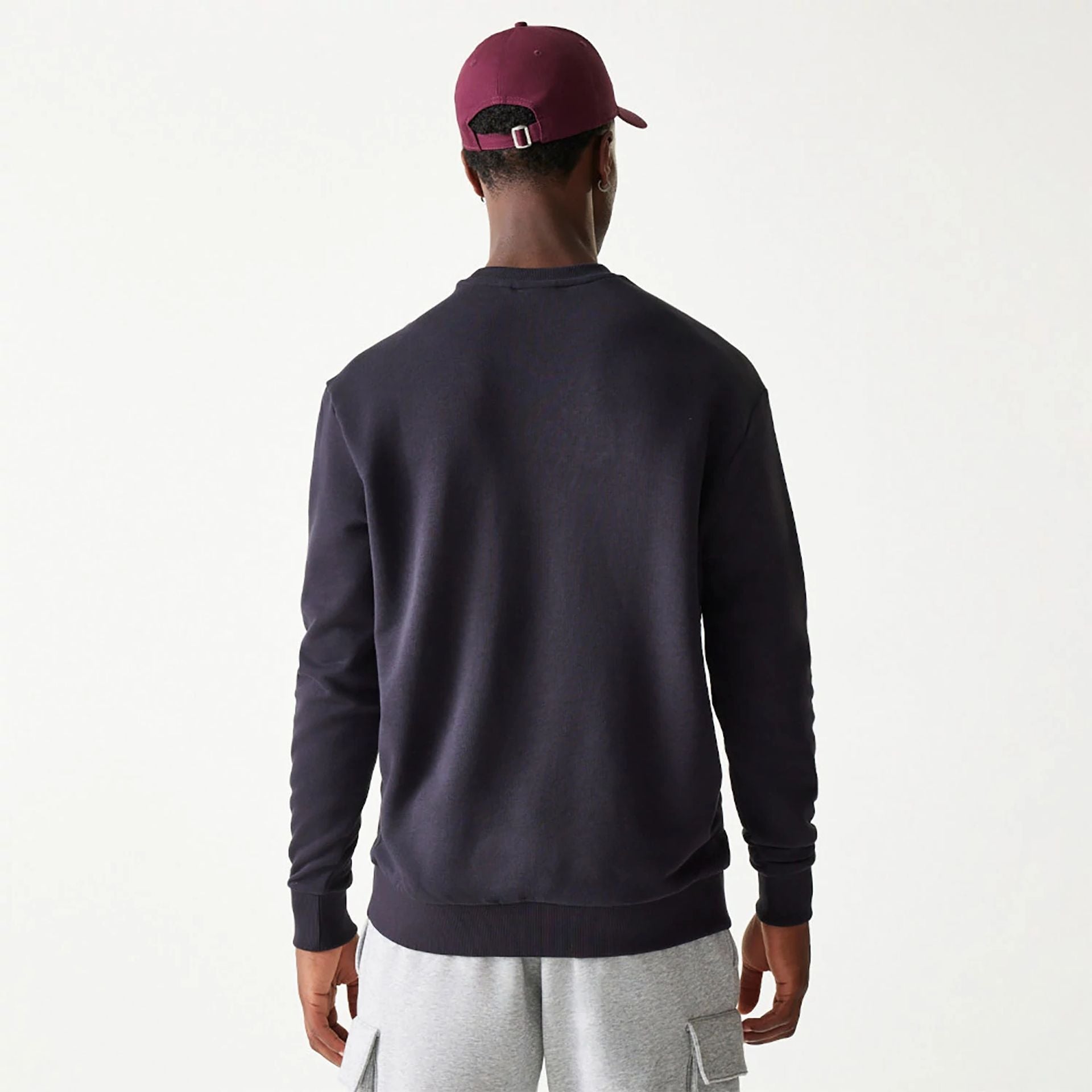 The Male model is wearing New Era Essential Navy Crewneck Sweater 2