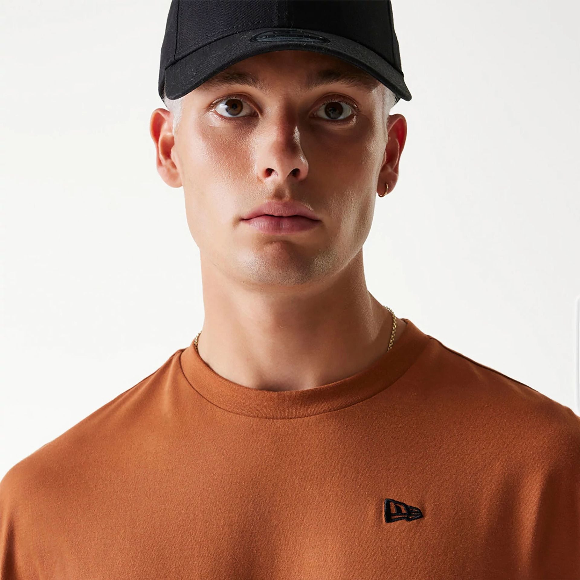 The Male model is wearing New Era Essential Brown Oversized T-Shirt 3