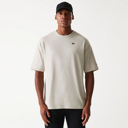 The Male model is wearing New Era Essential Light Beige Oversized T-Shirt 1