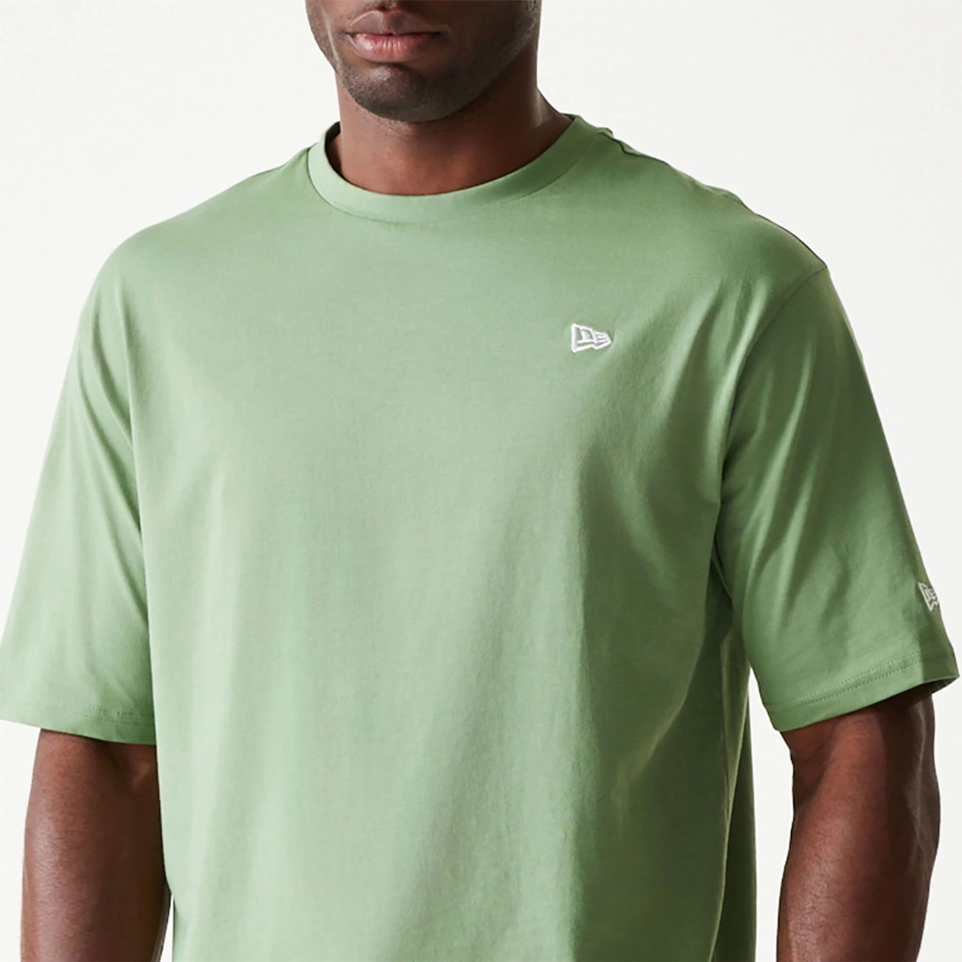 The Male model is wearing New Era Essential Green Oversized T-Shirt 3