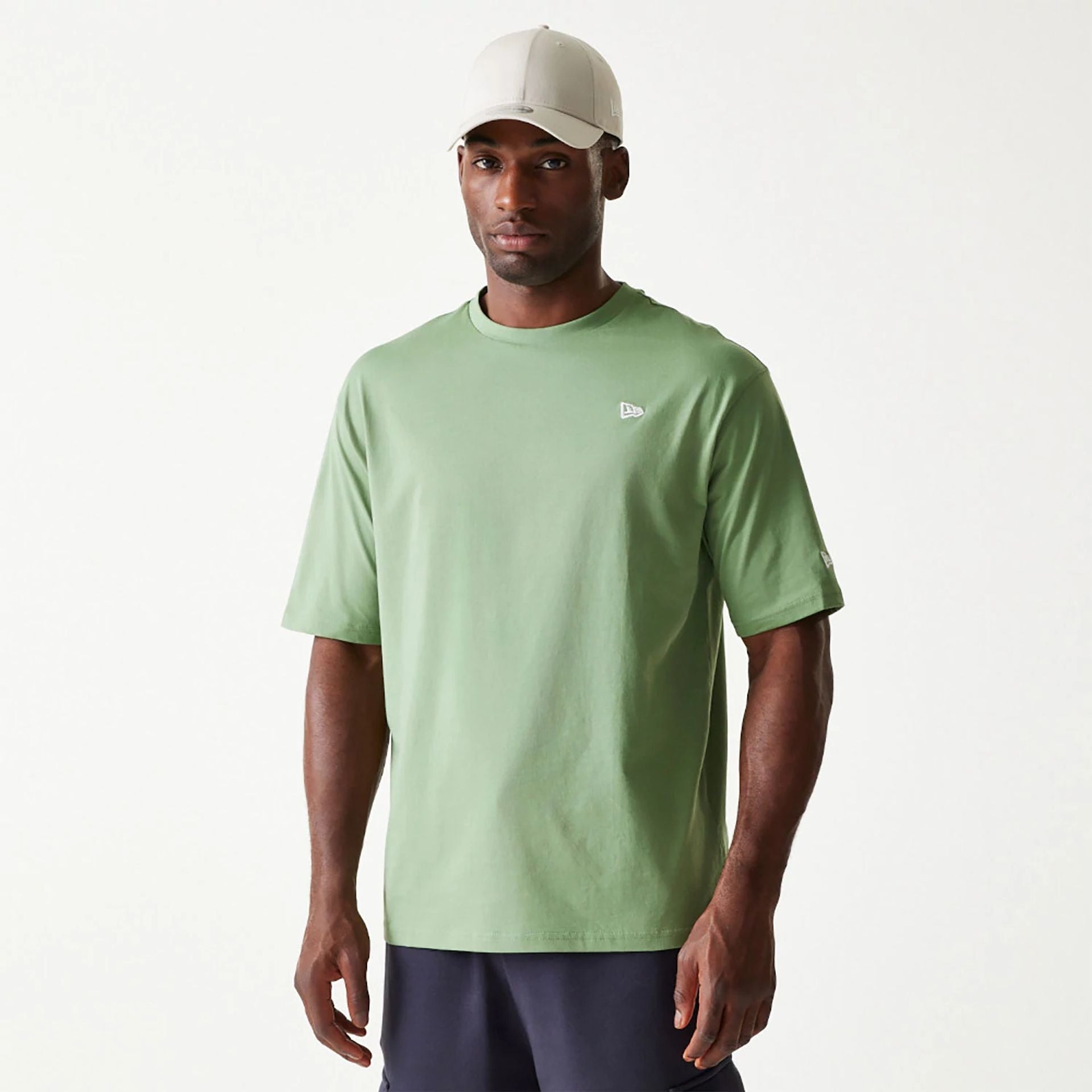 The Male model is wearing New Era Essential Green Oversized T-Shirt 1