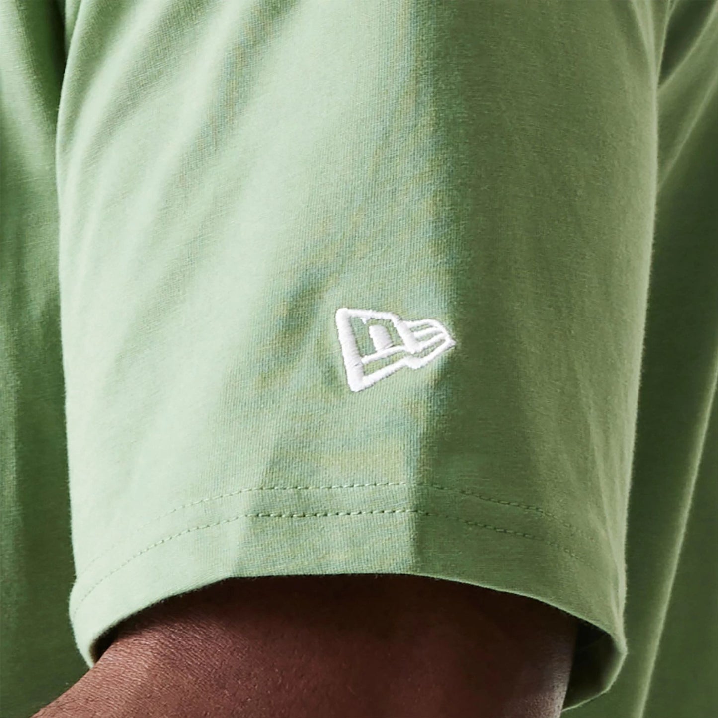 The Male model is wearing New Era Essential Green Oversized T-Shirt 5