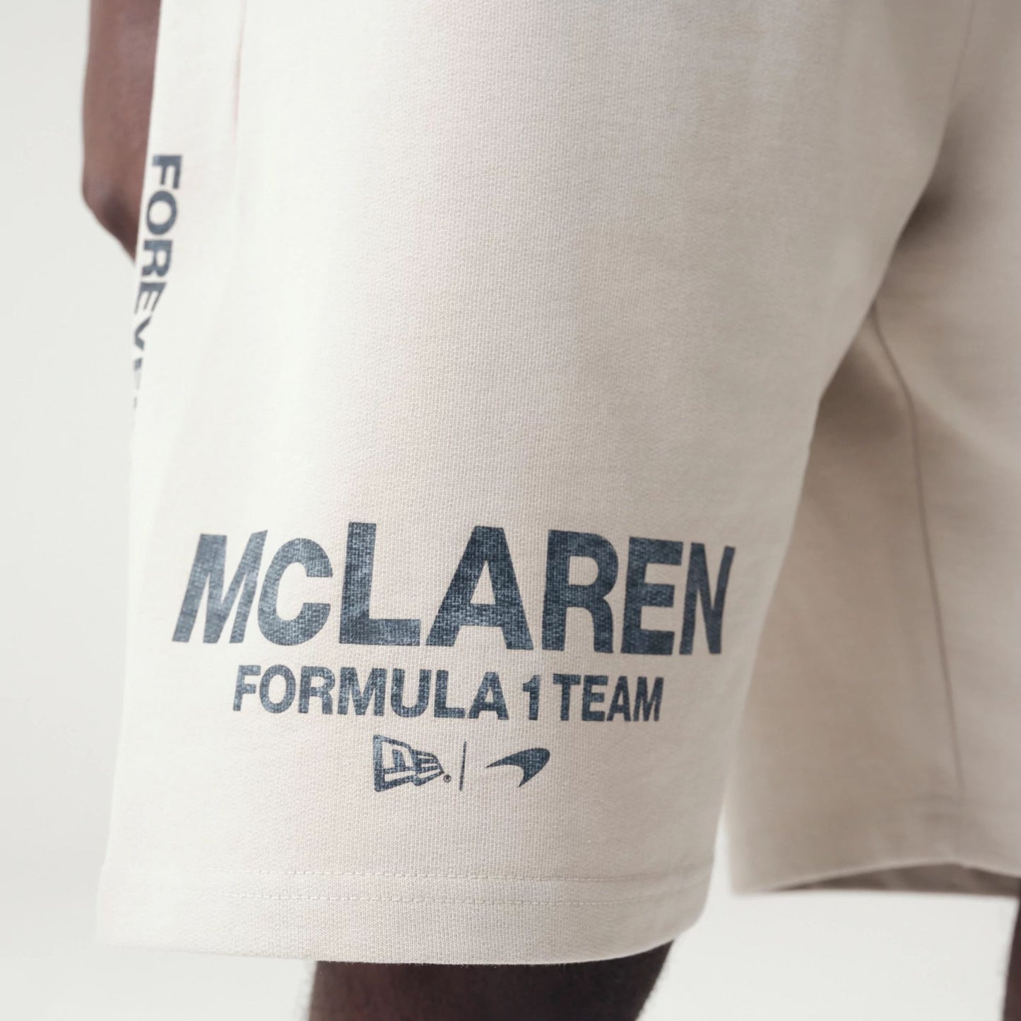 The Male model is wearing McLaren Racing Washed Pack Cream Oversized Shorts 5