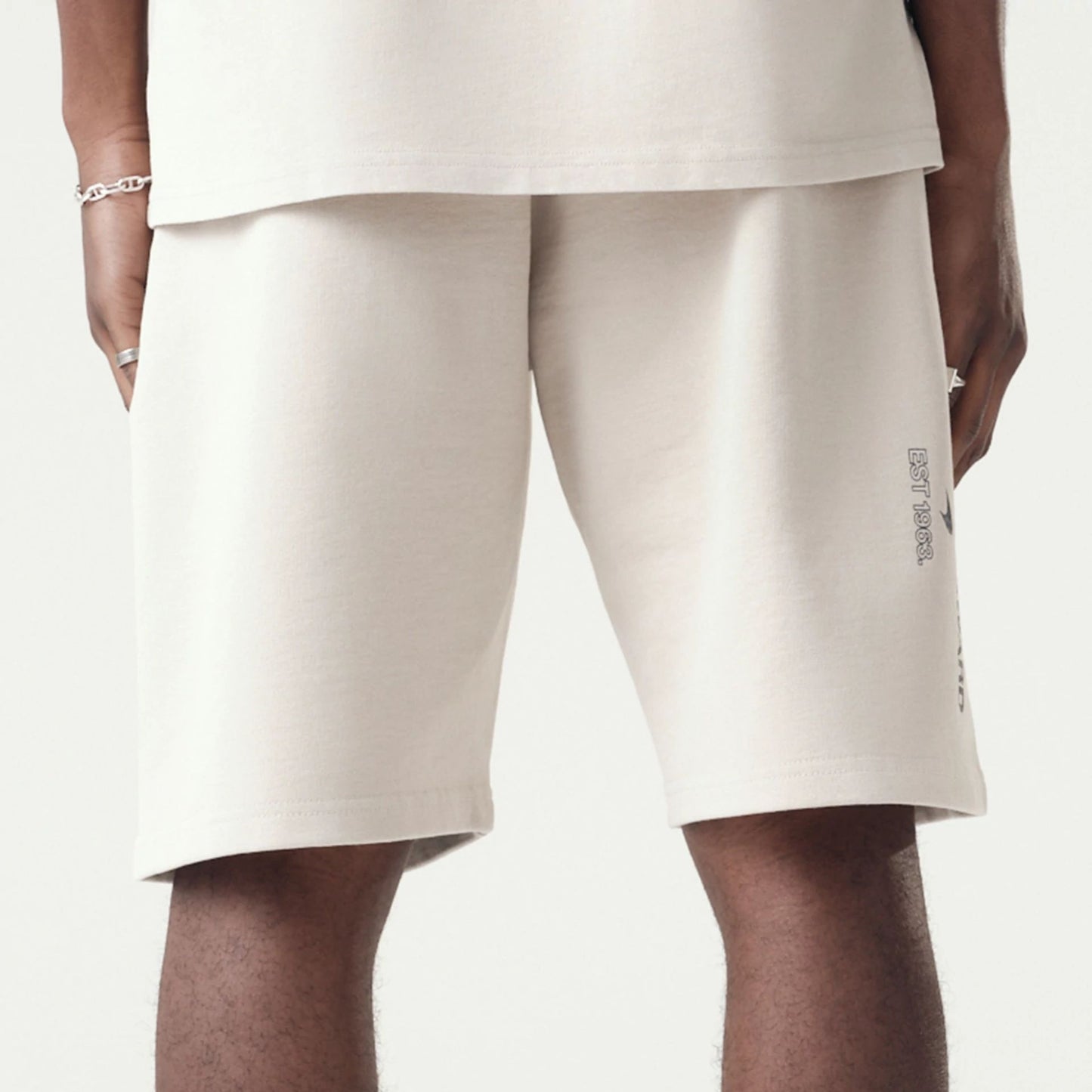 The Male model is wearing McLaren Racing Washed Pack Cream Oversized Shorts 7