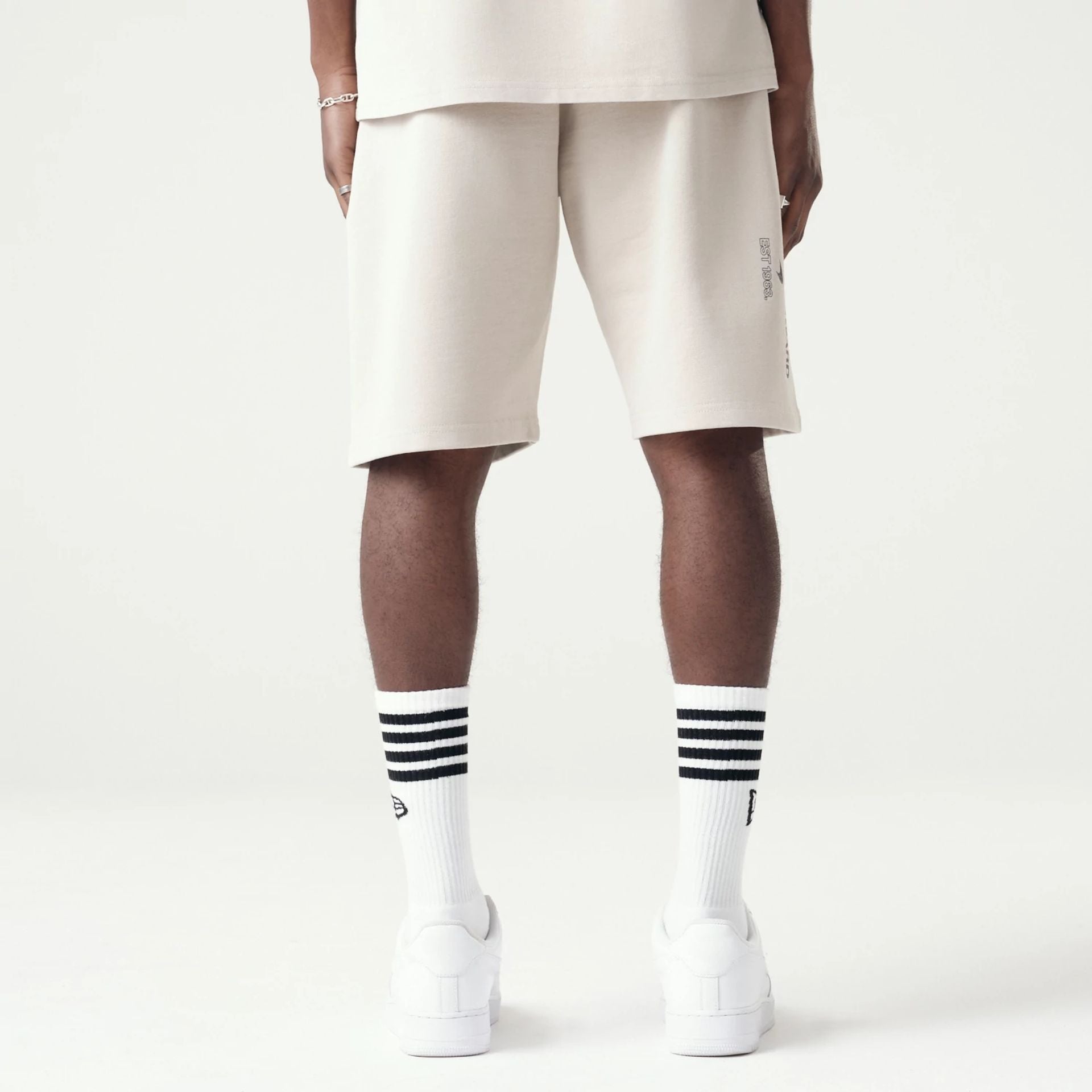 The Male model is wearing McLaren Racing Washed Pack Cream Oversized Shorts 2