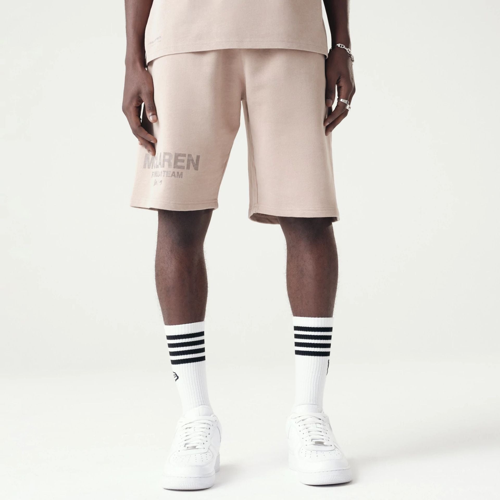 The Male model is wearing McLaren Racing Washed Pack Beige Oversized Shorts 1