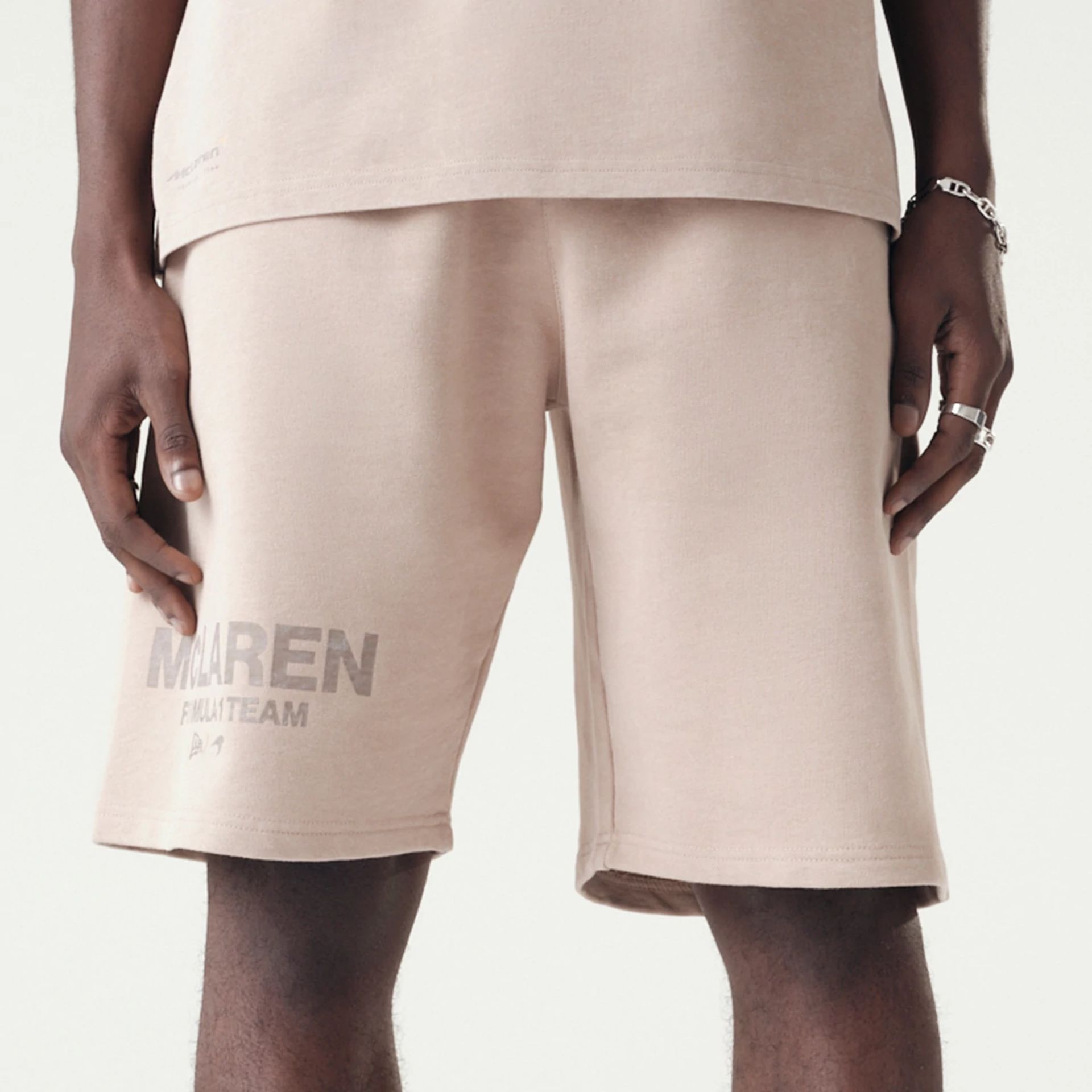 The Male model is wearing McLaren Racing Washed Pack Beige Oversized Shorts 3