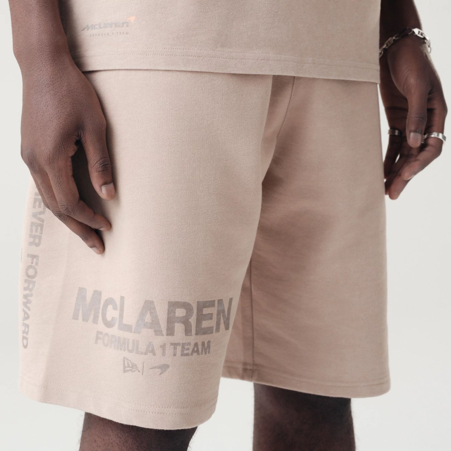 The Male model is wearing McLaren Racing Washed Pack Beige Oversized Shorts 5