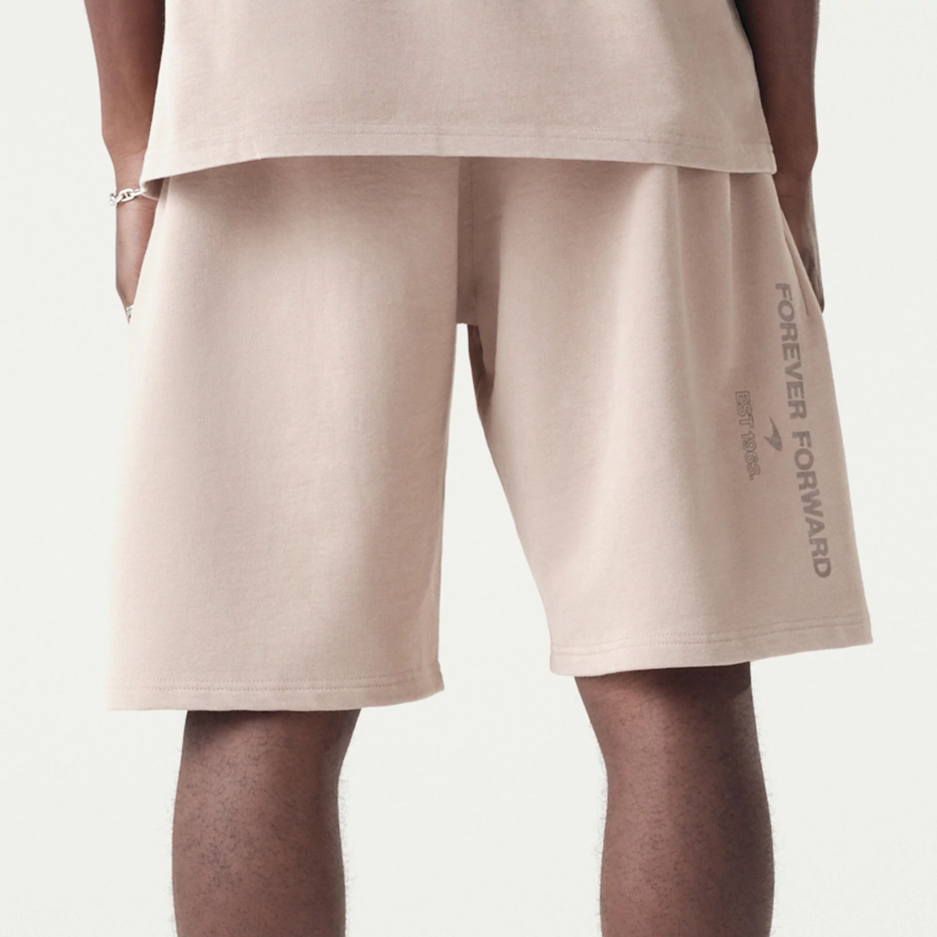 The Male model is wearing McLaren Racing Washed Pack Beige Oversized Shorts 7