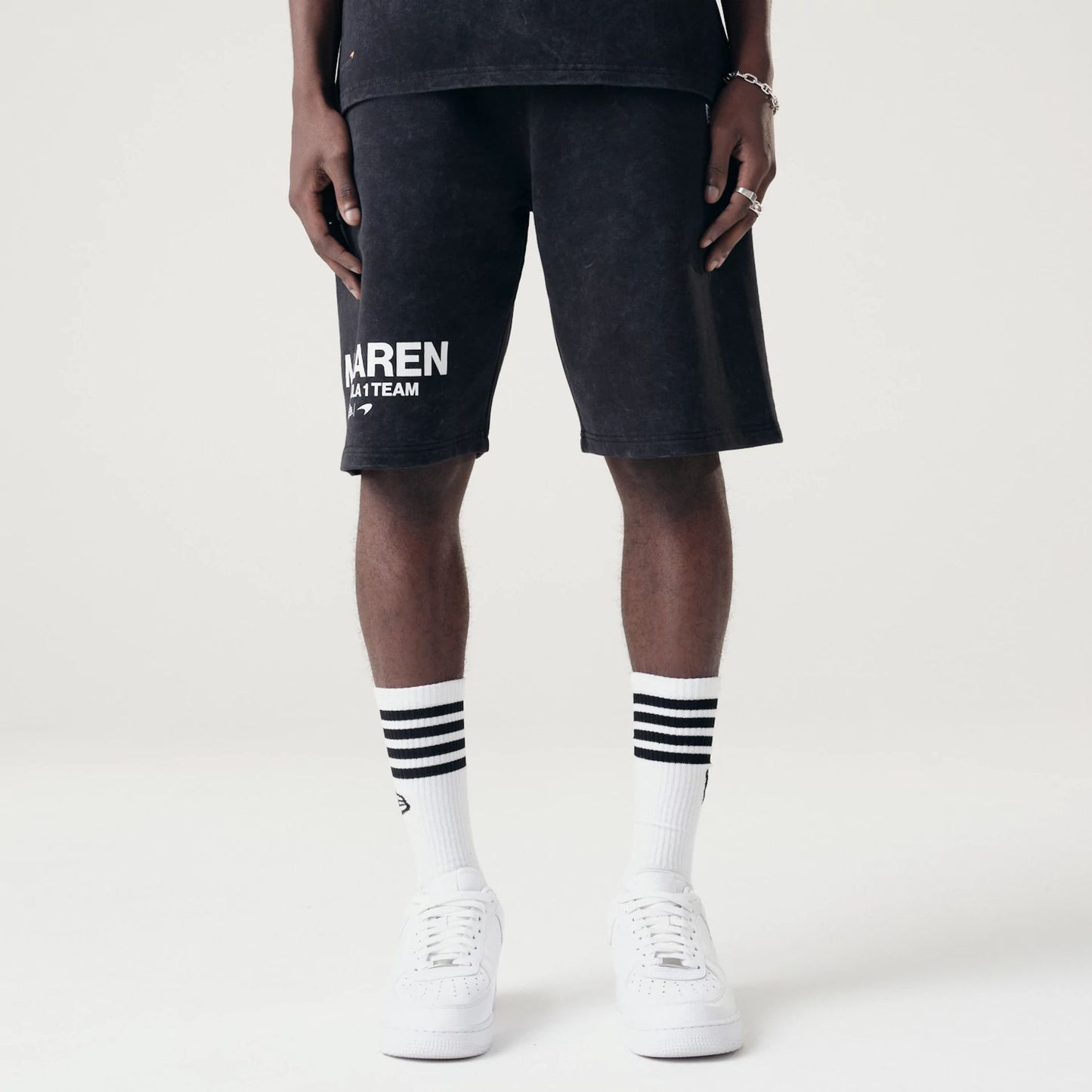 The Male model is wearing McLaren Racing Washed Pack Black Oversized Shorts 1