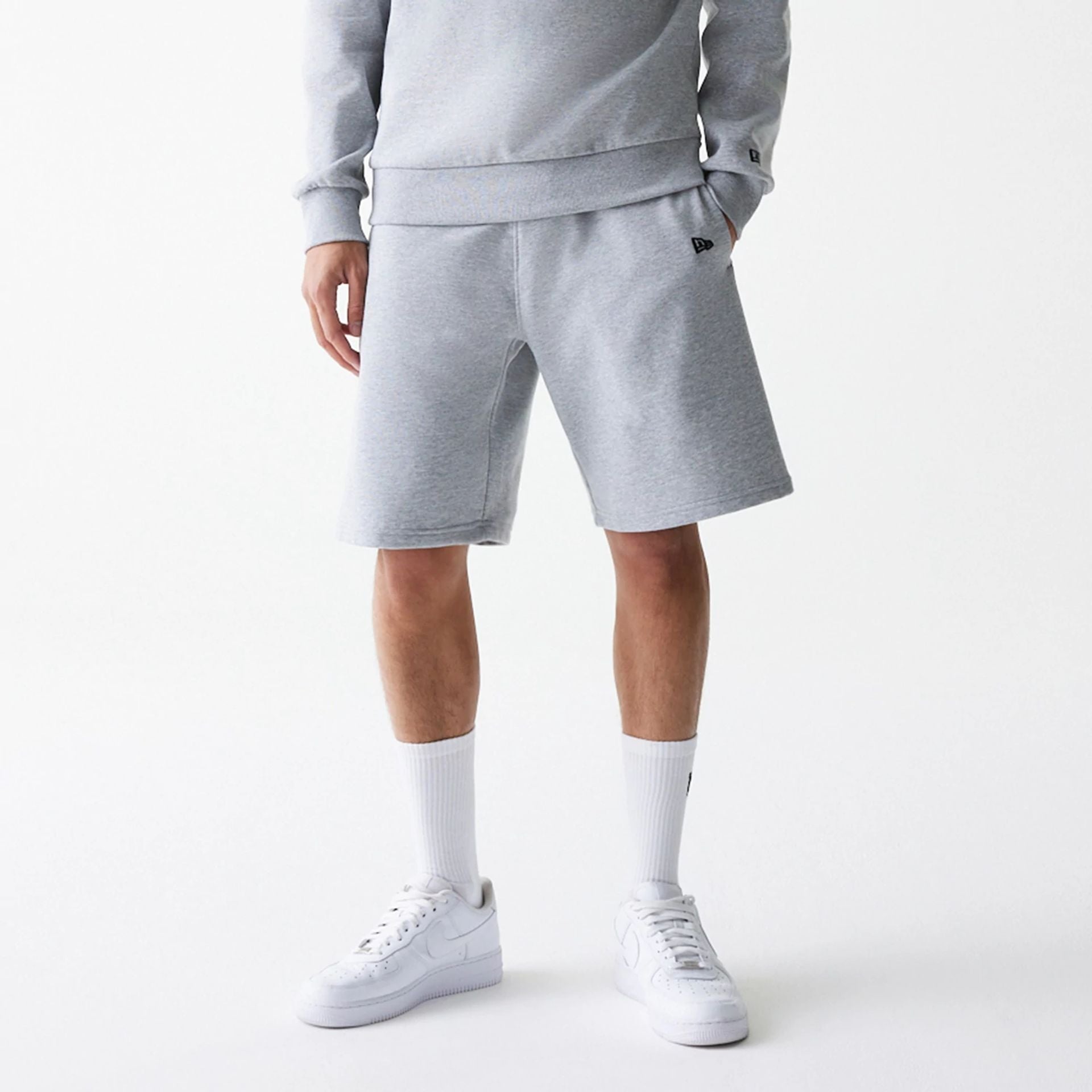 The Male model is wearing New Era Grey Oversized One Panel Shorts 1