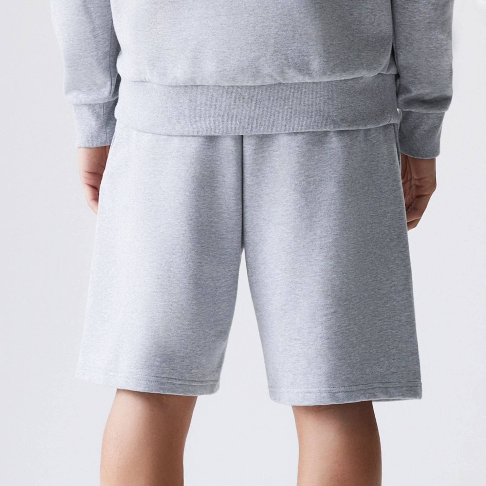 The Male model is wearing New Era Grey Oversized One Panel Shorts 7