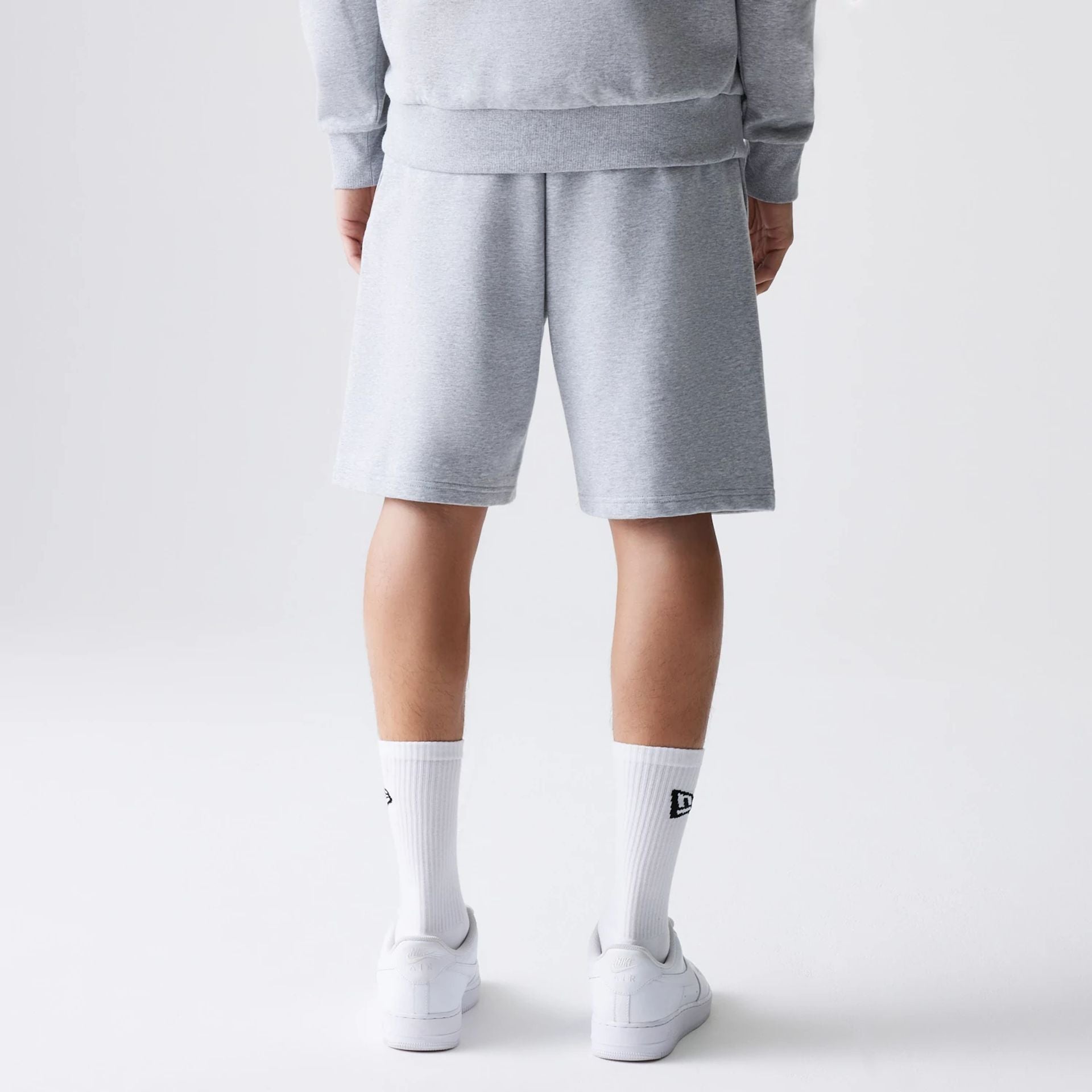 The Male model is wearing New Era Grey Oversized One Panel Shorts 2