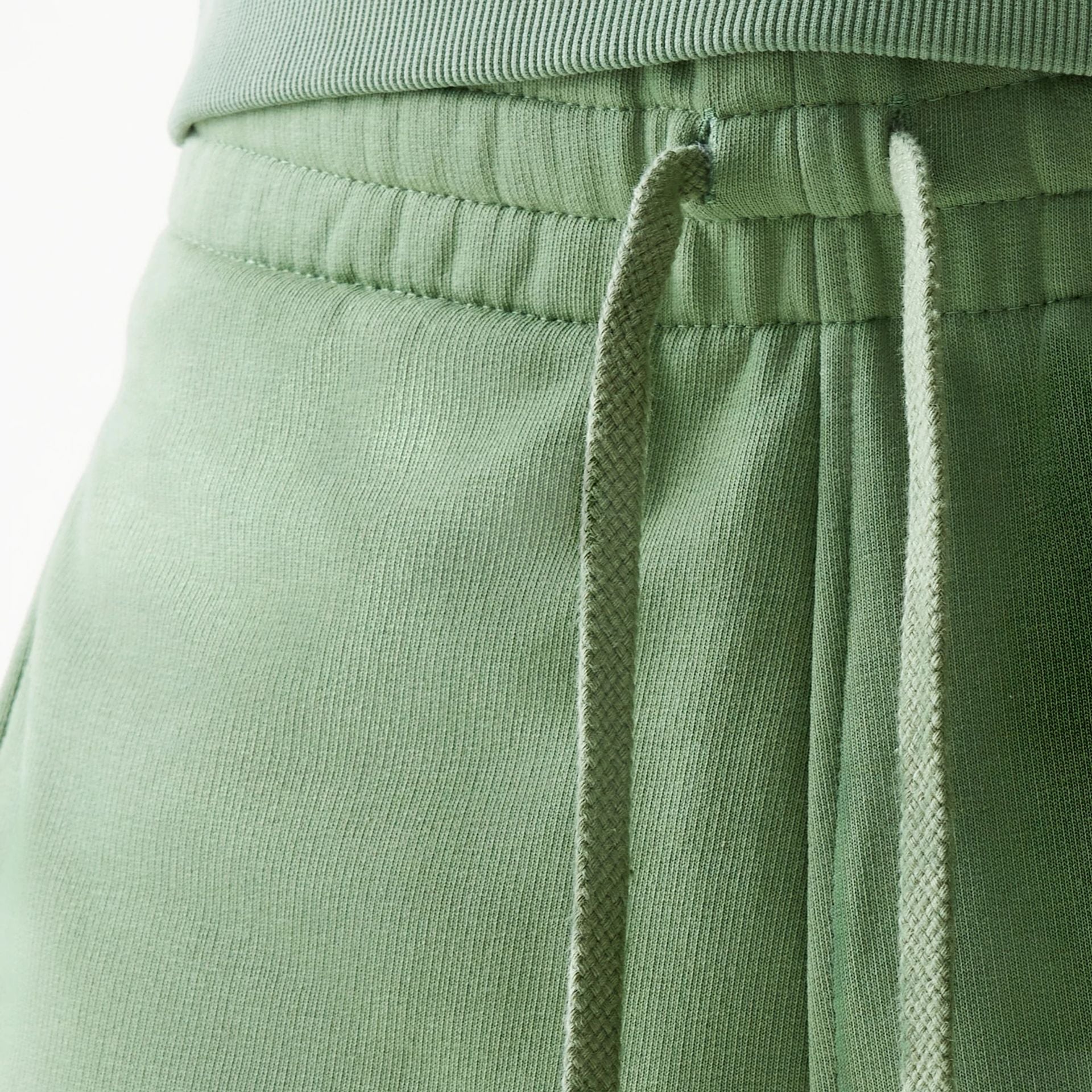 The Male model is wearing New Era Green Oversized One Panel Shorts 4