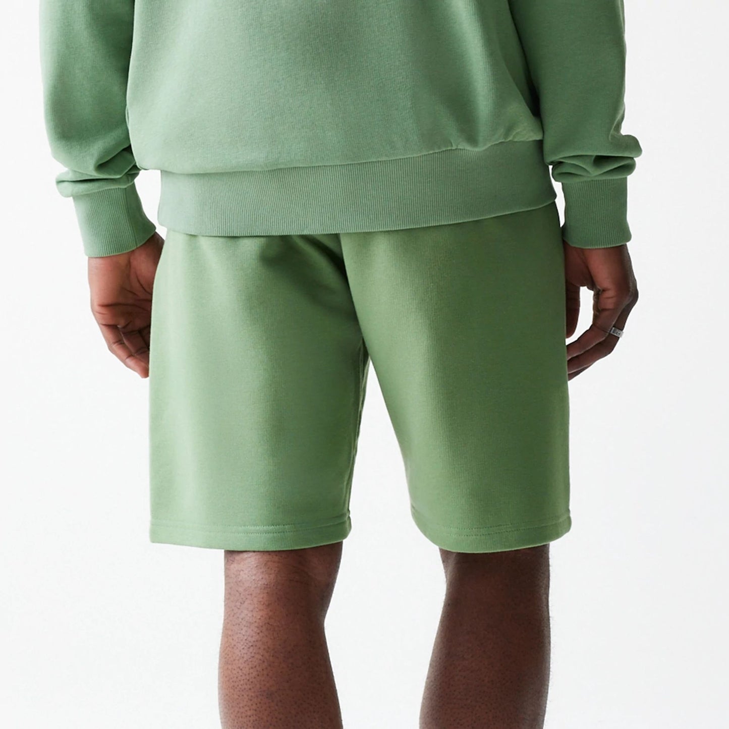 The Male model is wearing New Era Green Oversized One Panel Shorts 6