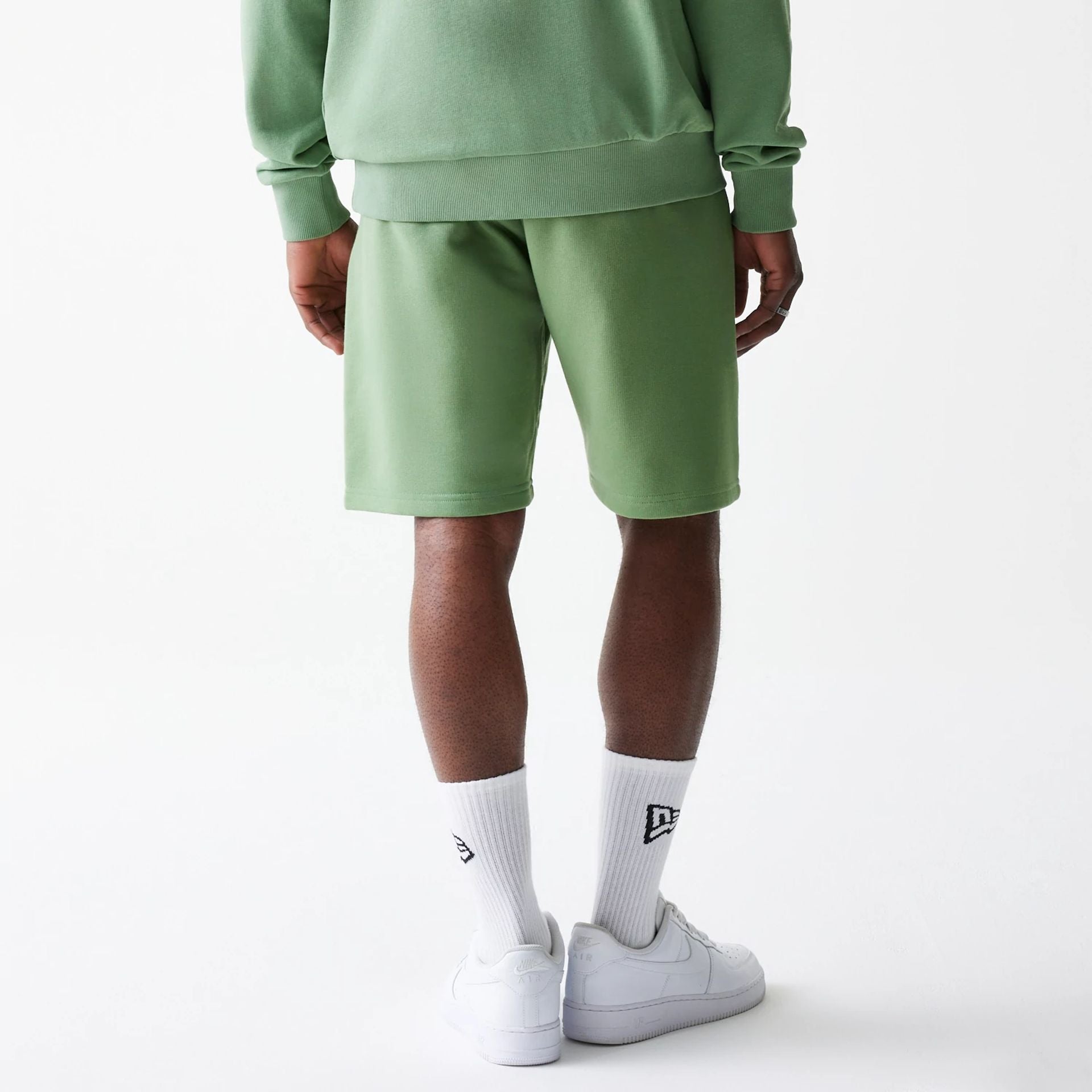 The Male model is wearing New Era Green Oversized One Panel Shorts 2