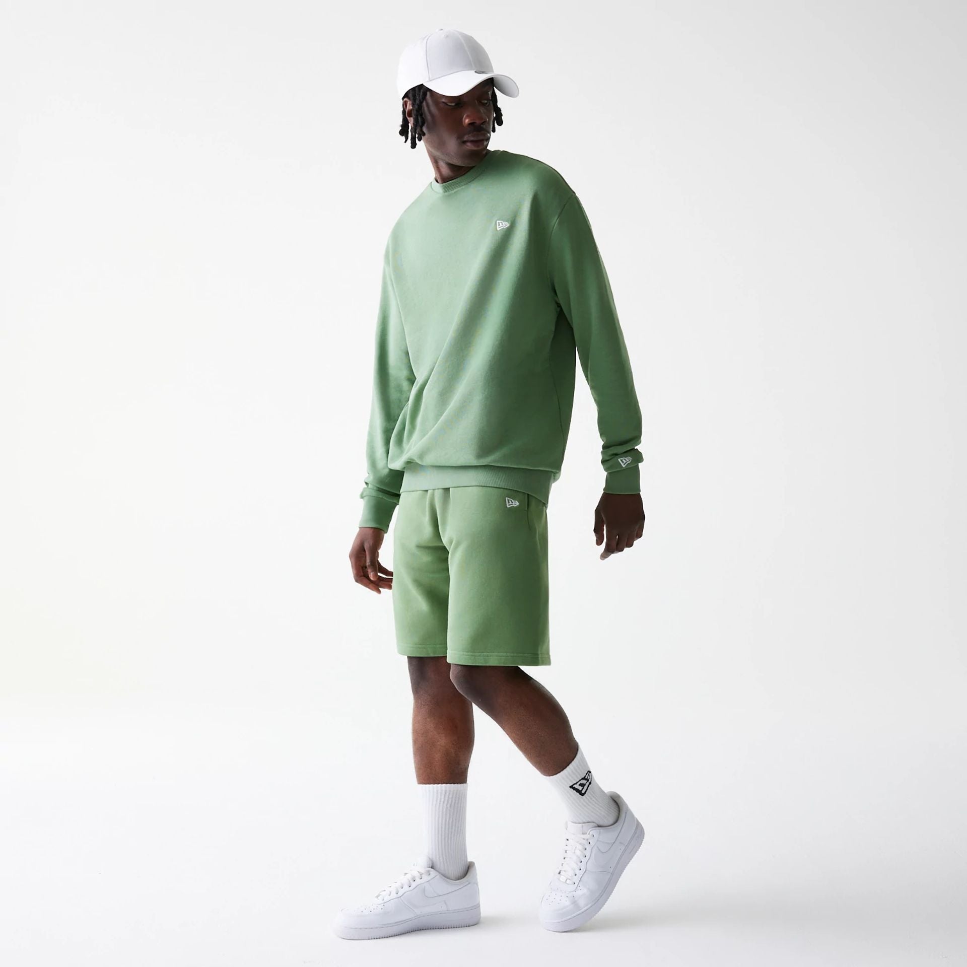 The Male model is wearing New Era Green Oversized One Panel Shorts 8