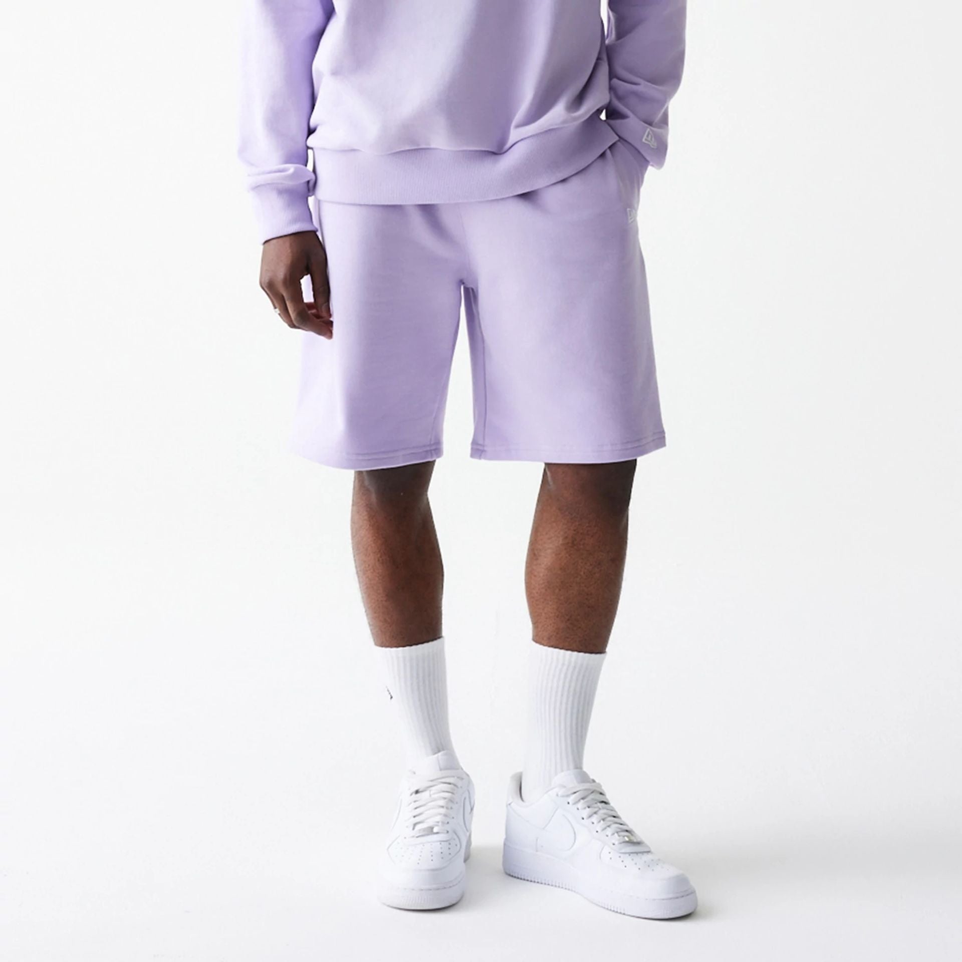 The Male model is wearing New Era Pastel Purple Oversized One Panel Shorts 1