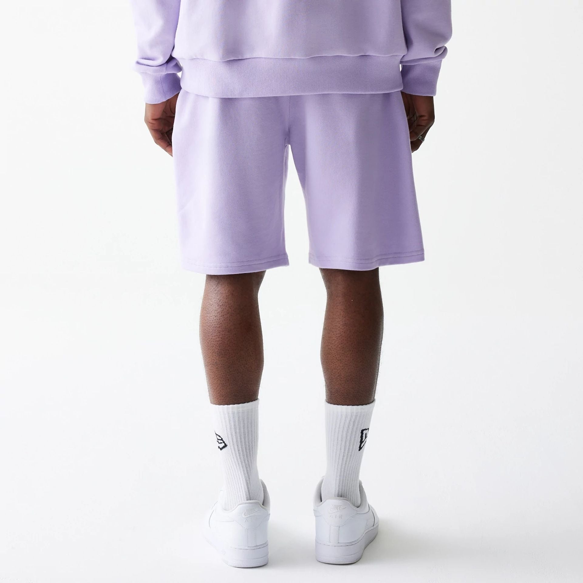 The Male model is wearing New Era Pastel Purple Oversized One Panel Shorts 2