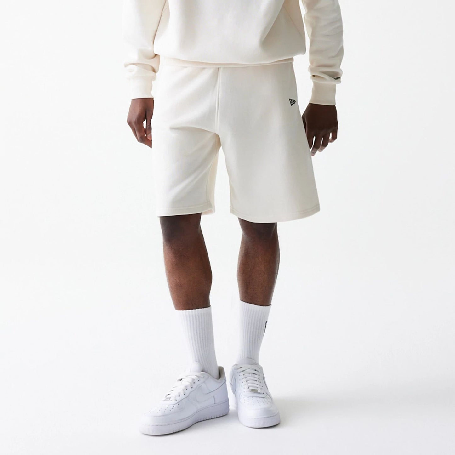 The Male model is wearing New Era Open White Oversized One Panel Shorts 6