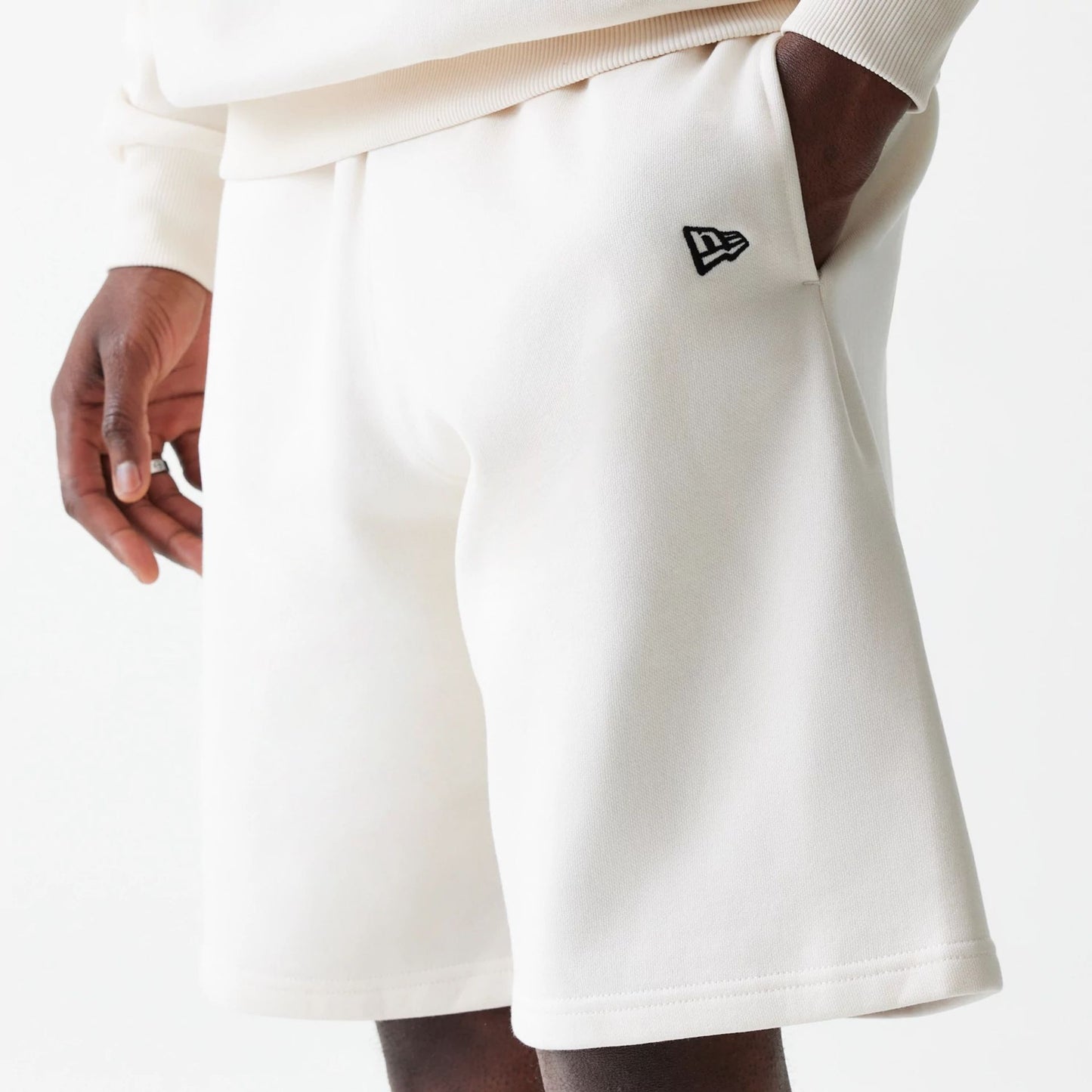 The Male model is wearing New Era Open White Oversized One Panel Shorts 3